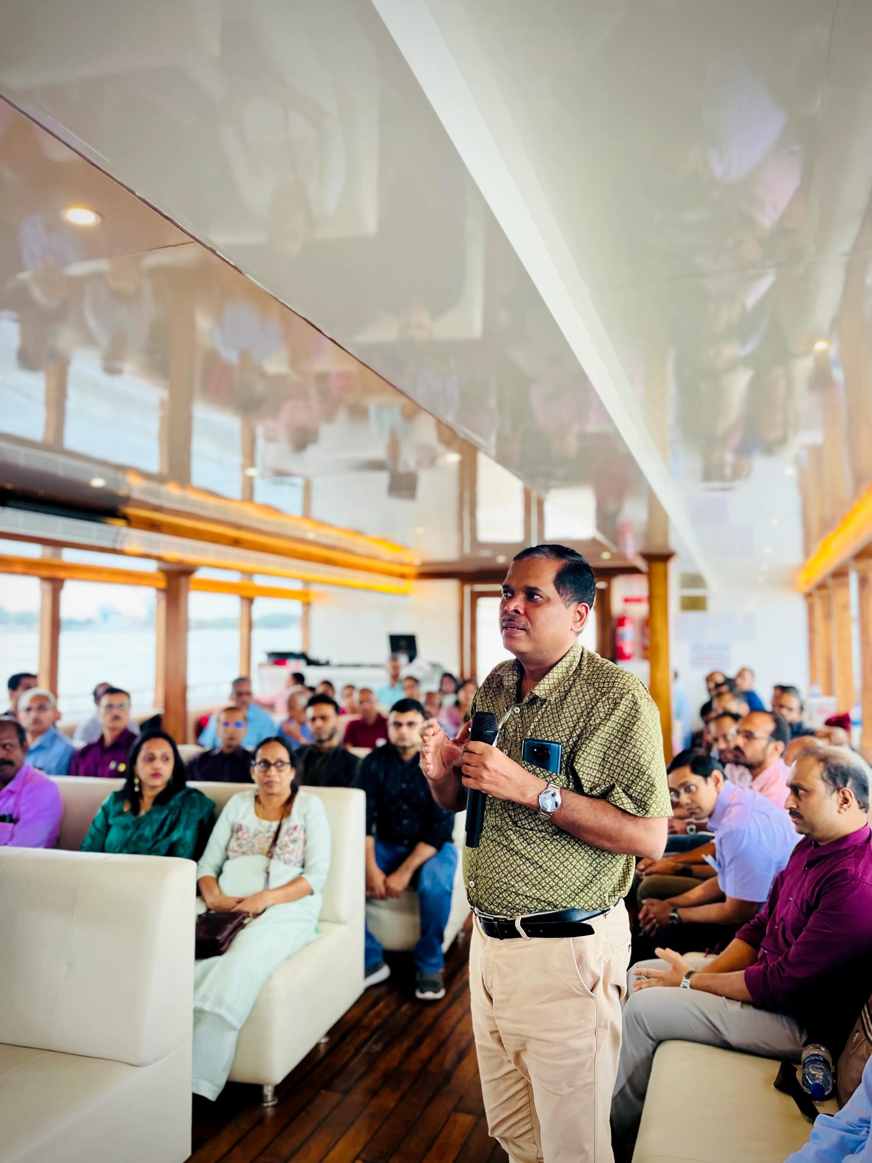 A man speaking in mic Official meeting held in the modern multipurpose facility of Minar Cruise