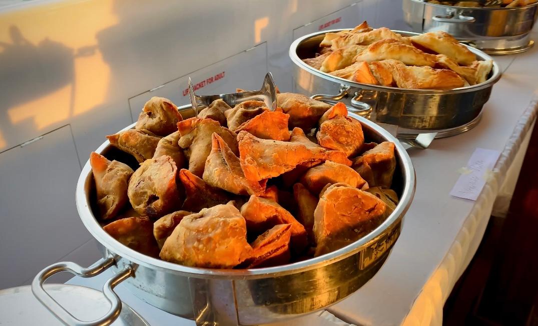 Delicious Indian appetizers served on Minar Cruise Samosas and pastries in silver chafing dishes