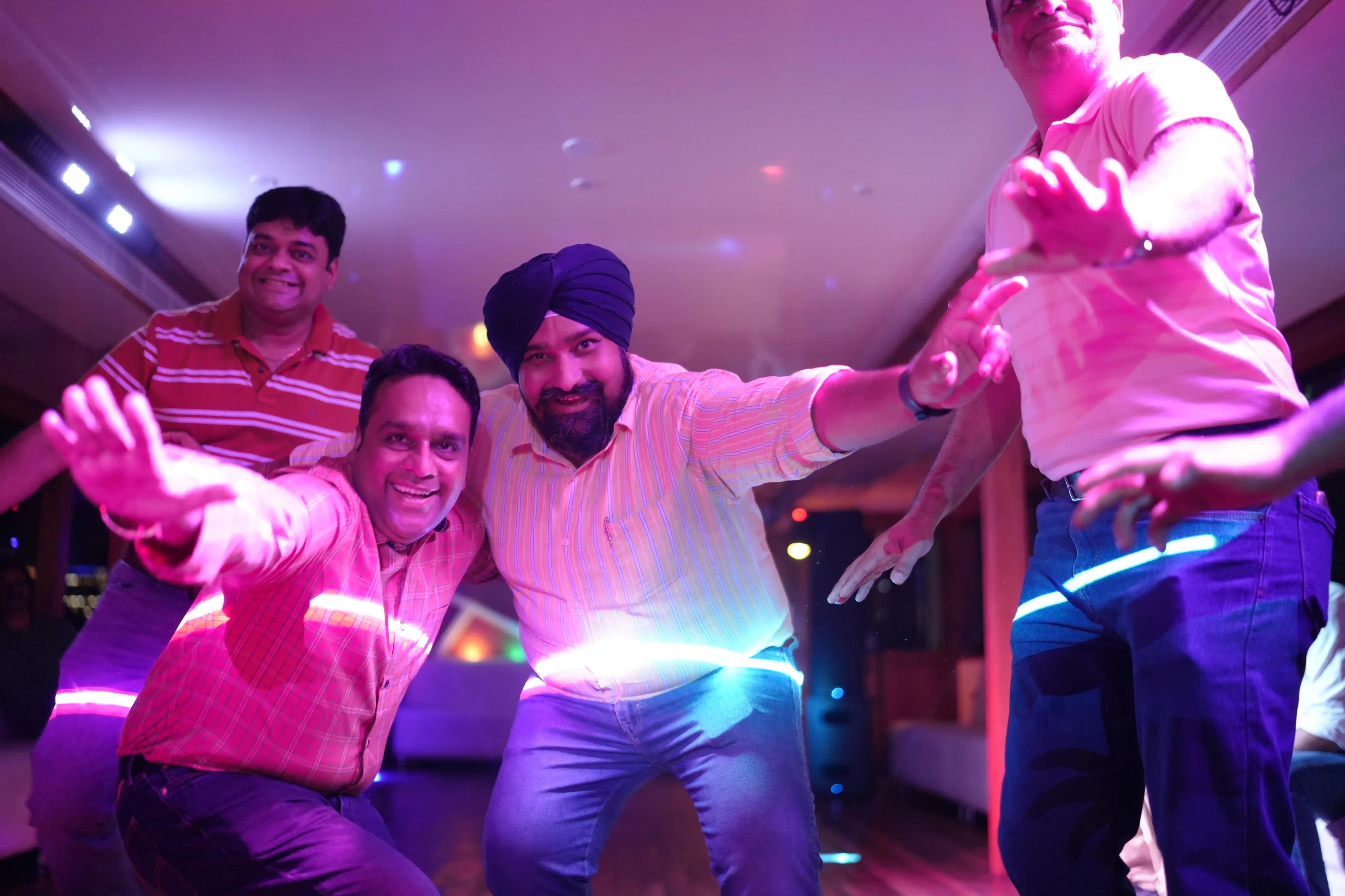 Passengers enjoying a festive atmosphere on a catamaran cruise in Kochi, India