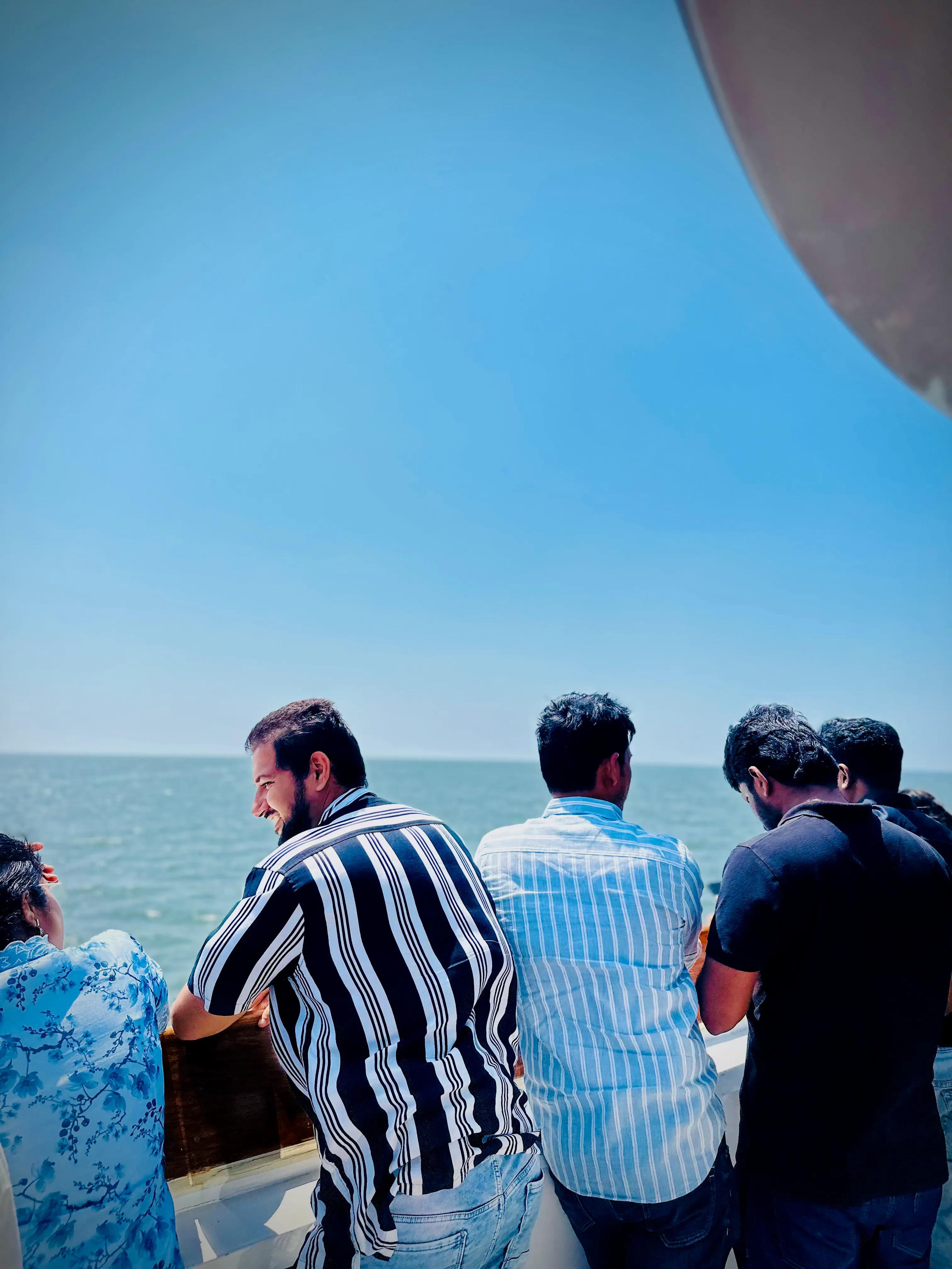 Guests on Minar Cruise enjoying a sunny day and ocean views while cruising along the Arabian Sea.