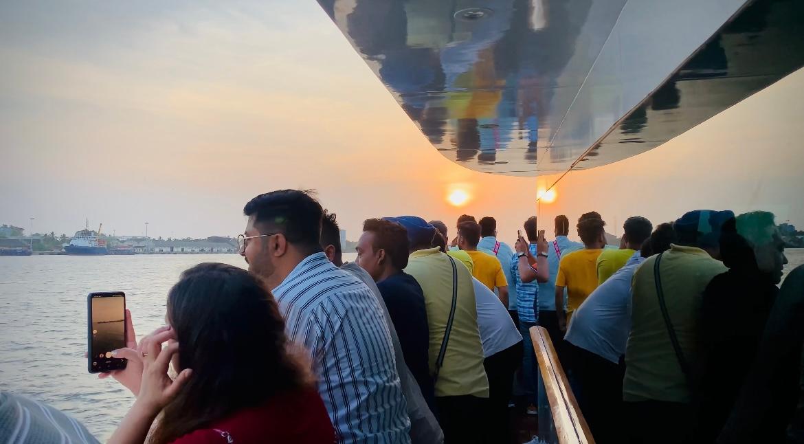 Passengers aboard Minar Cruise enjoying a peaceful sunset cruise in Kochi