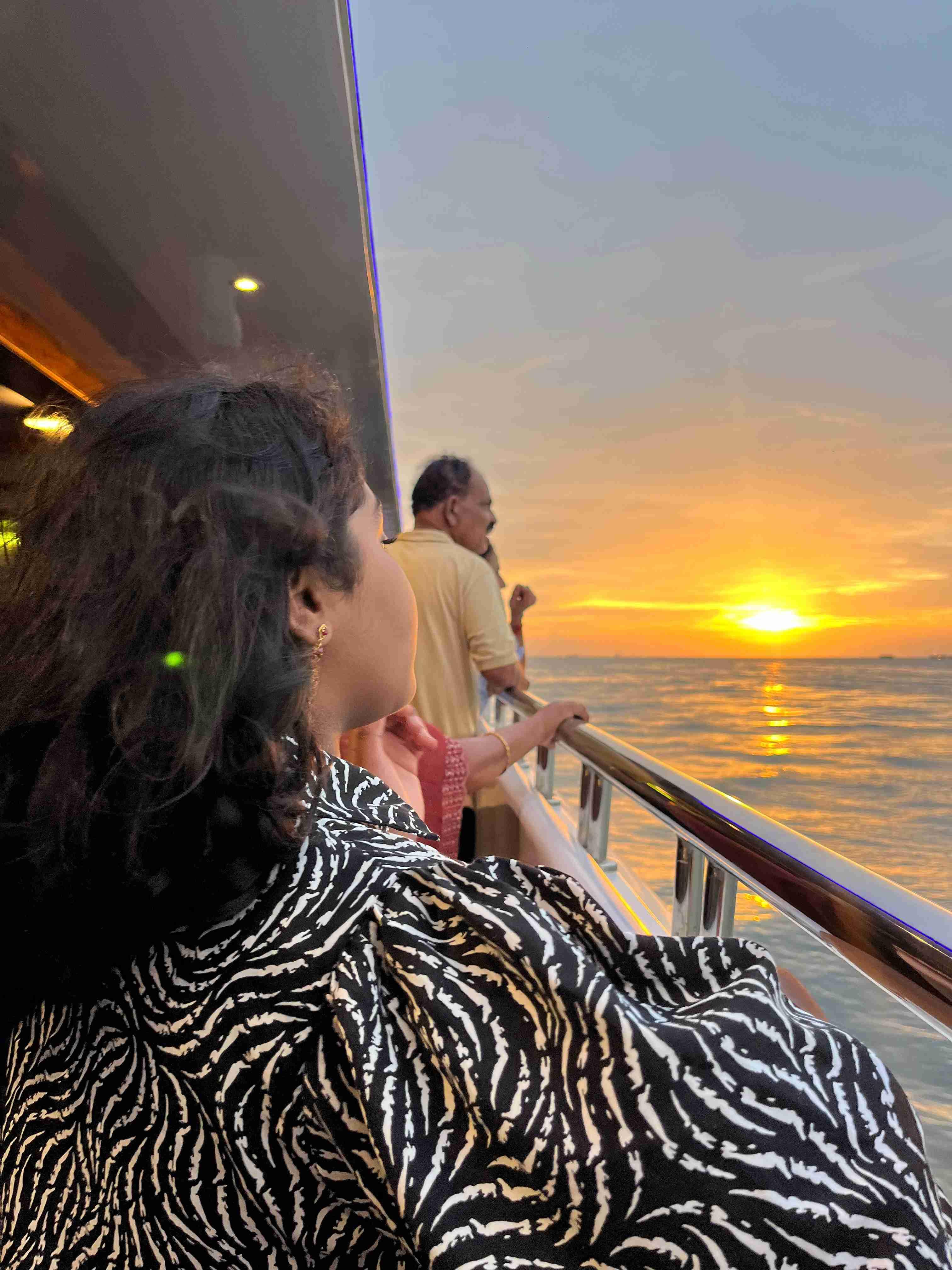 A stunning sunset over the Arabian Sea, viewed from the deck of a catamaran cruise