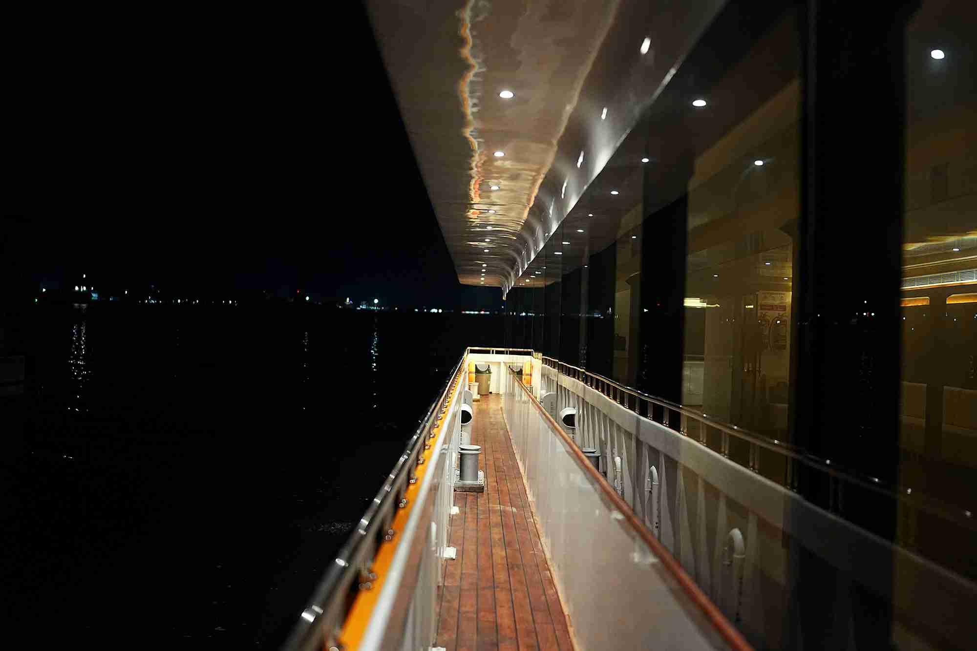 Scenic nighttime view from Minar Cruise deck offering serene reflections over the Arabian Sea