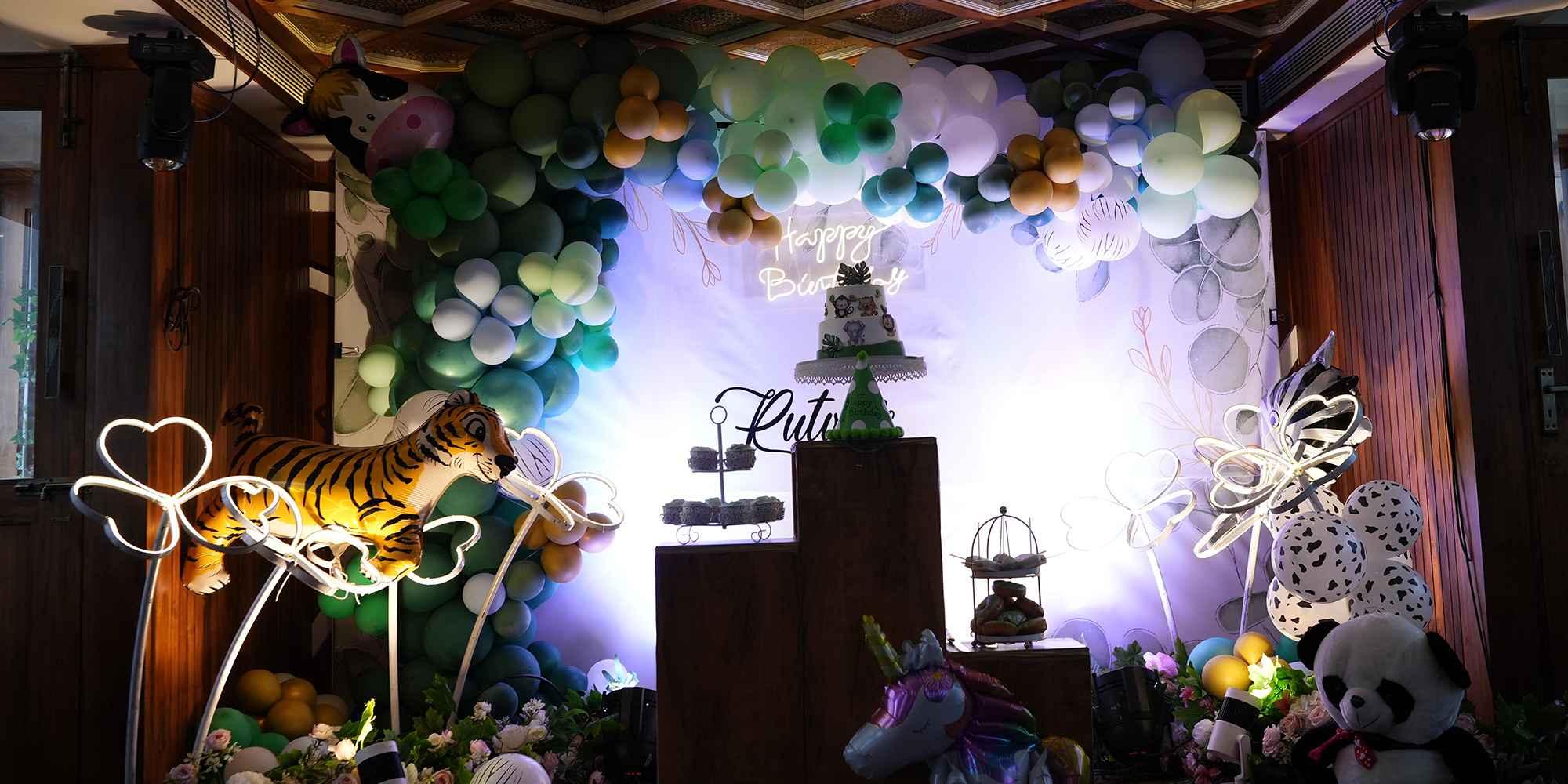 Colorful birthday party decorations aboard Minar Cruise with balloon and animal-themed setup