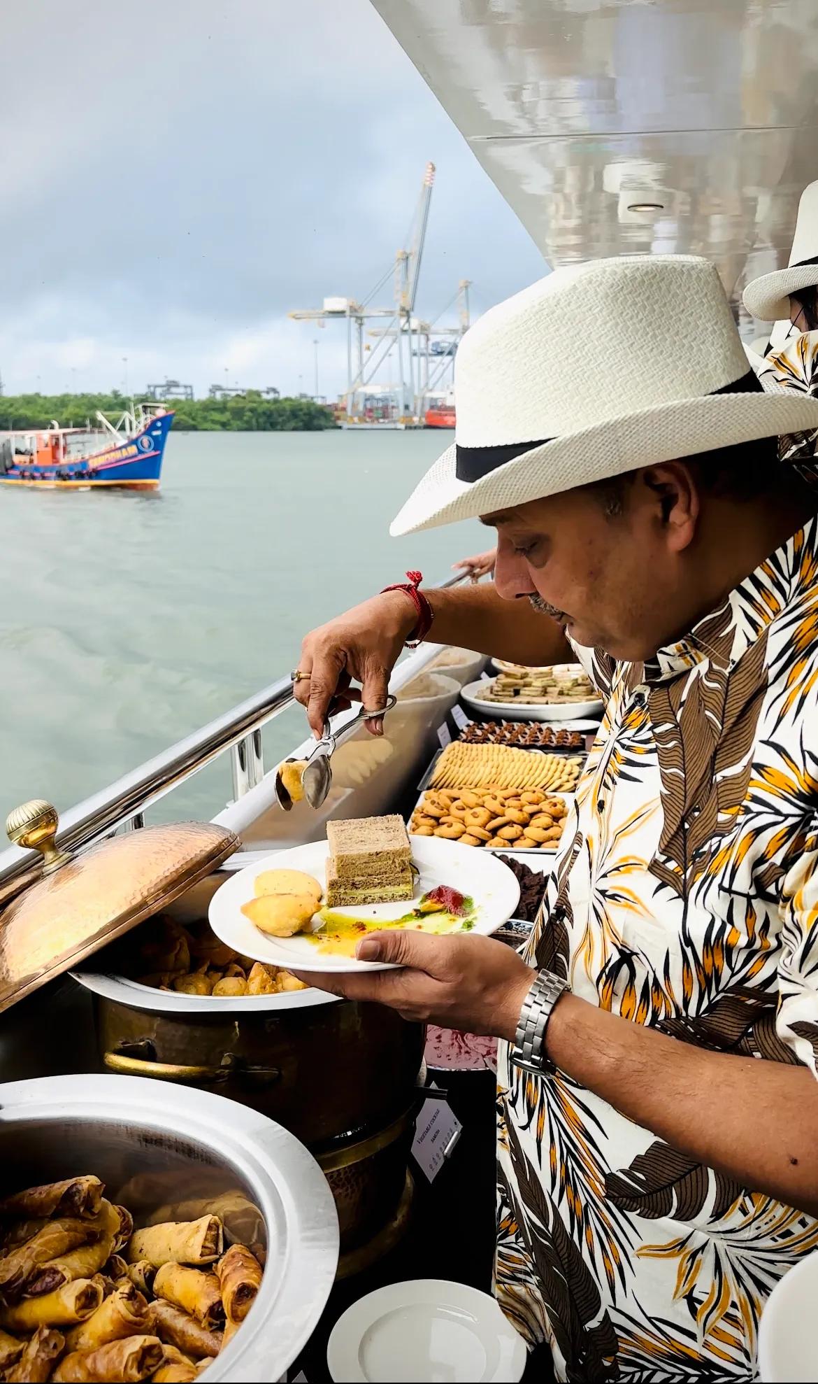 Guest enjoying buffet on Minar Cruise overlooking scenic Kochi backwaters