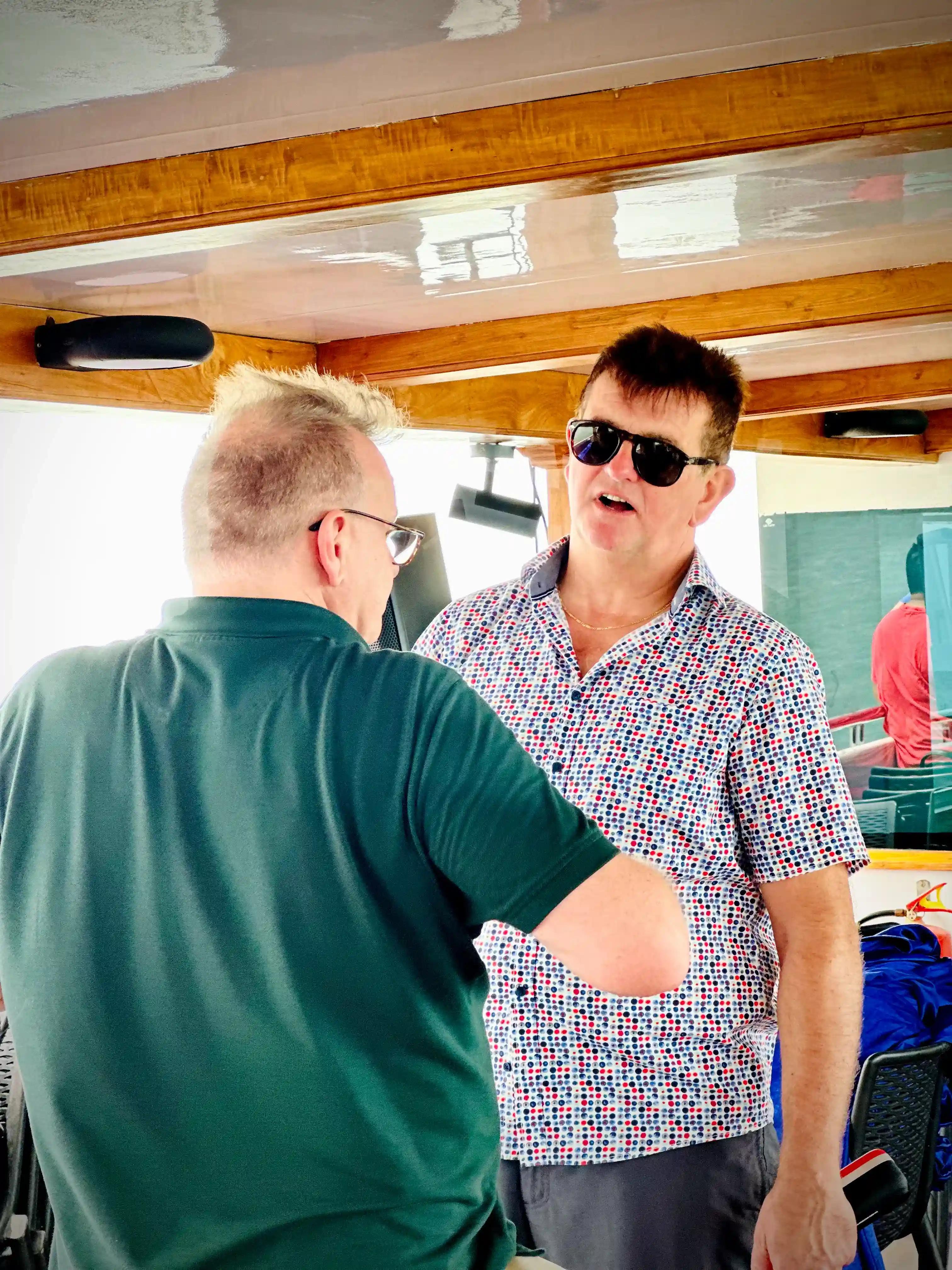 Two foreigners enjoying and having chat scenic cruise on Minar Cruise, Kerala, India