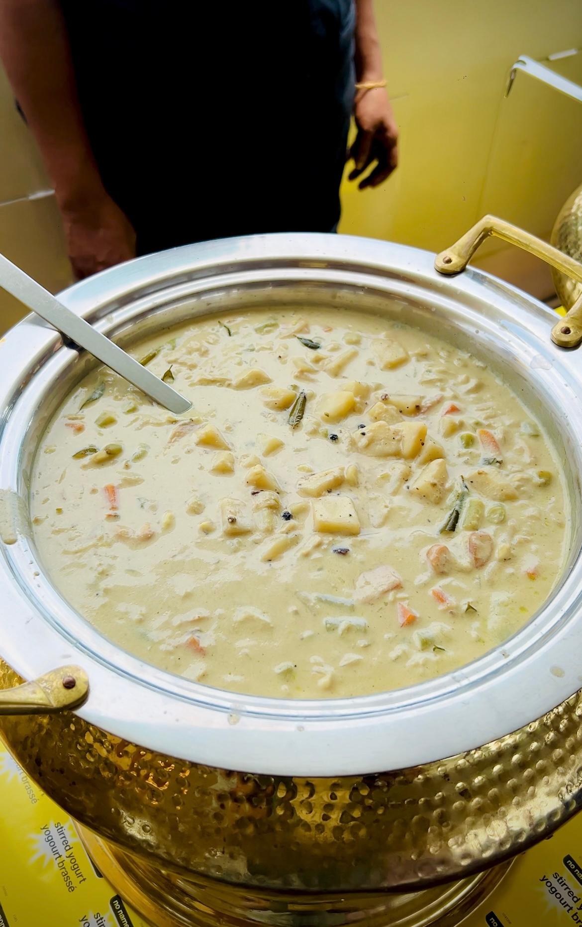 A close-up of a stew dish of Indian chicken curry being served on a catamaran cruise